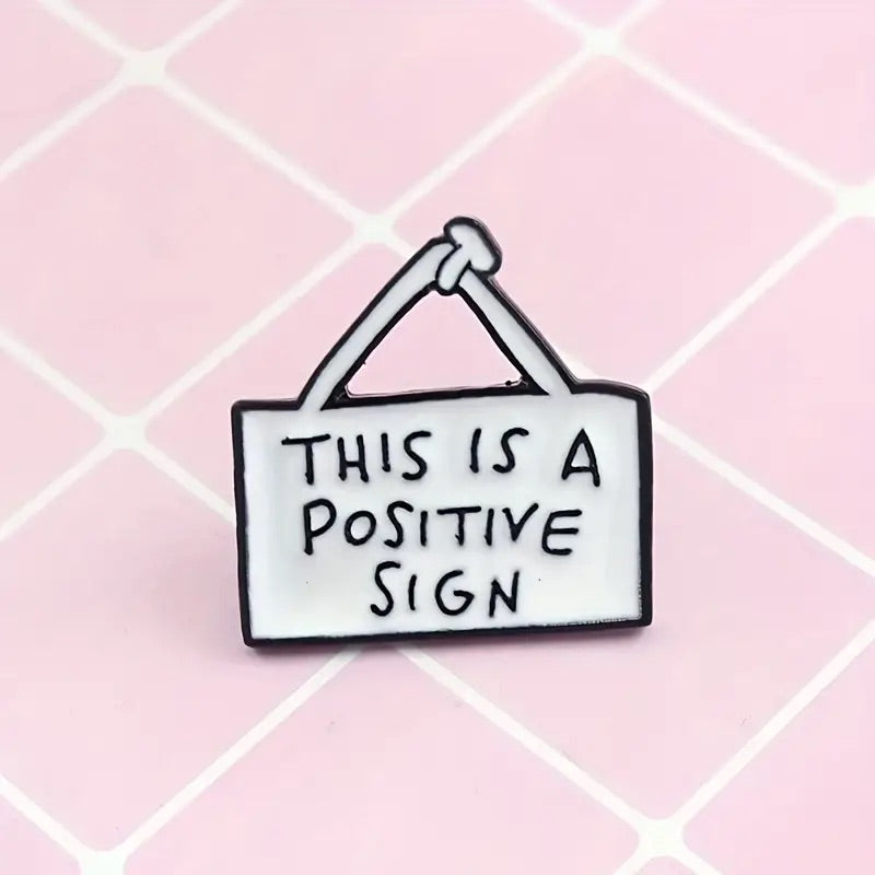 Positive sign enamel pin