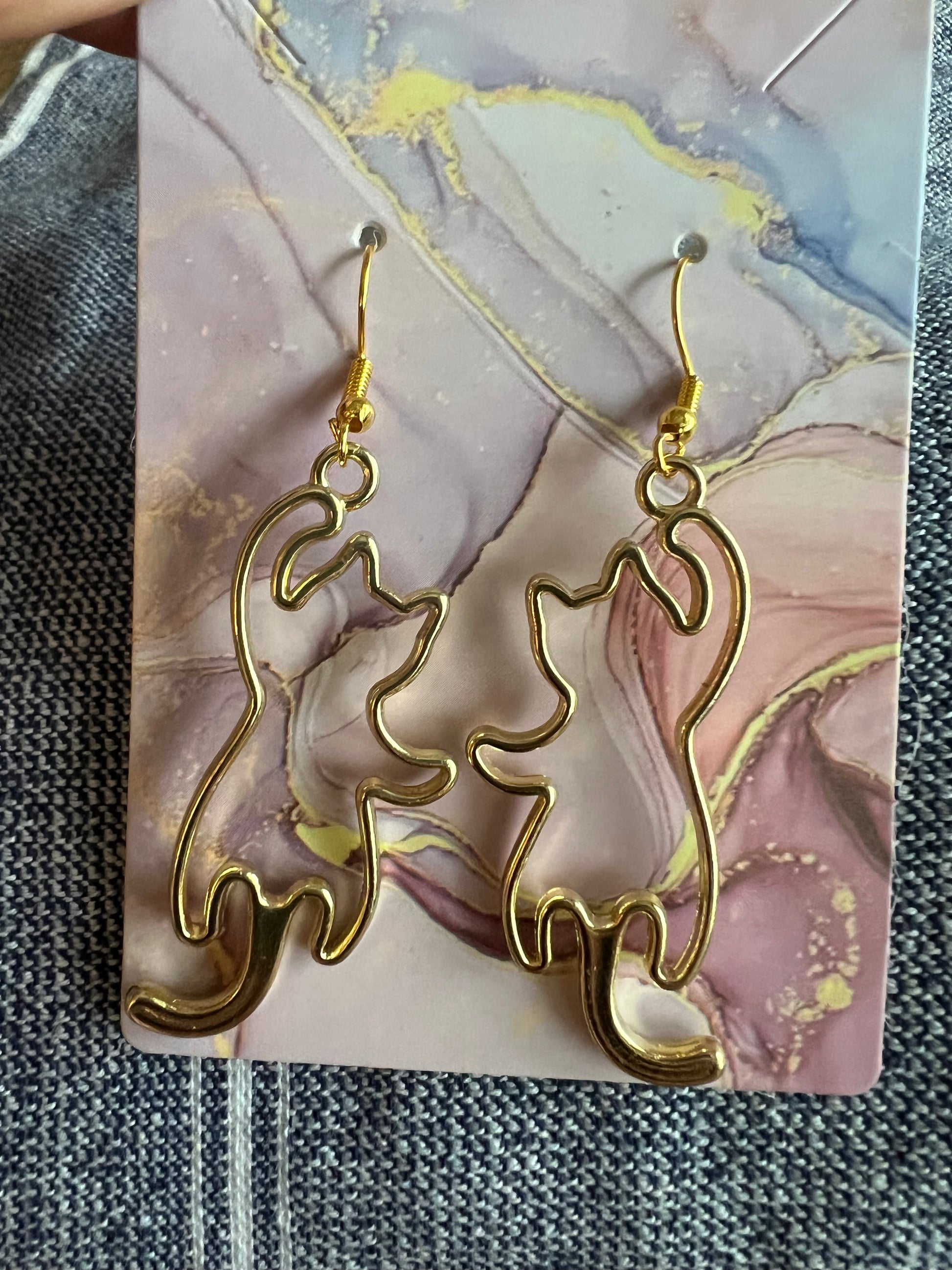 Golden open frame cat earrings