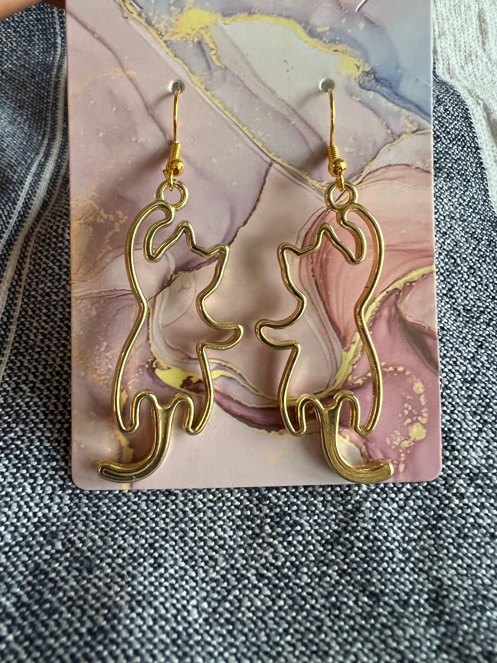 Golden open frame cat earrings