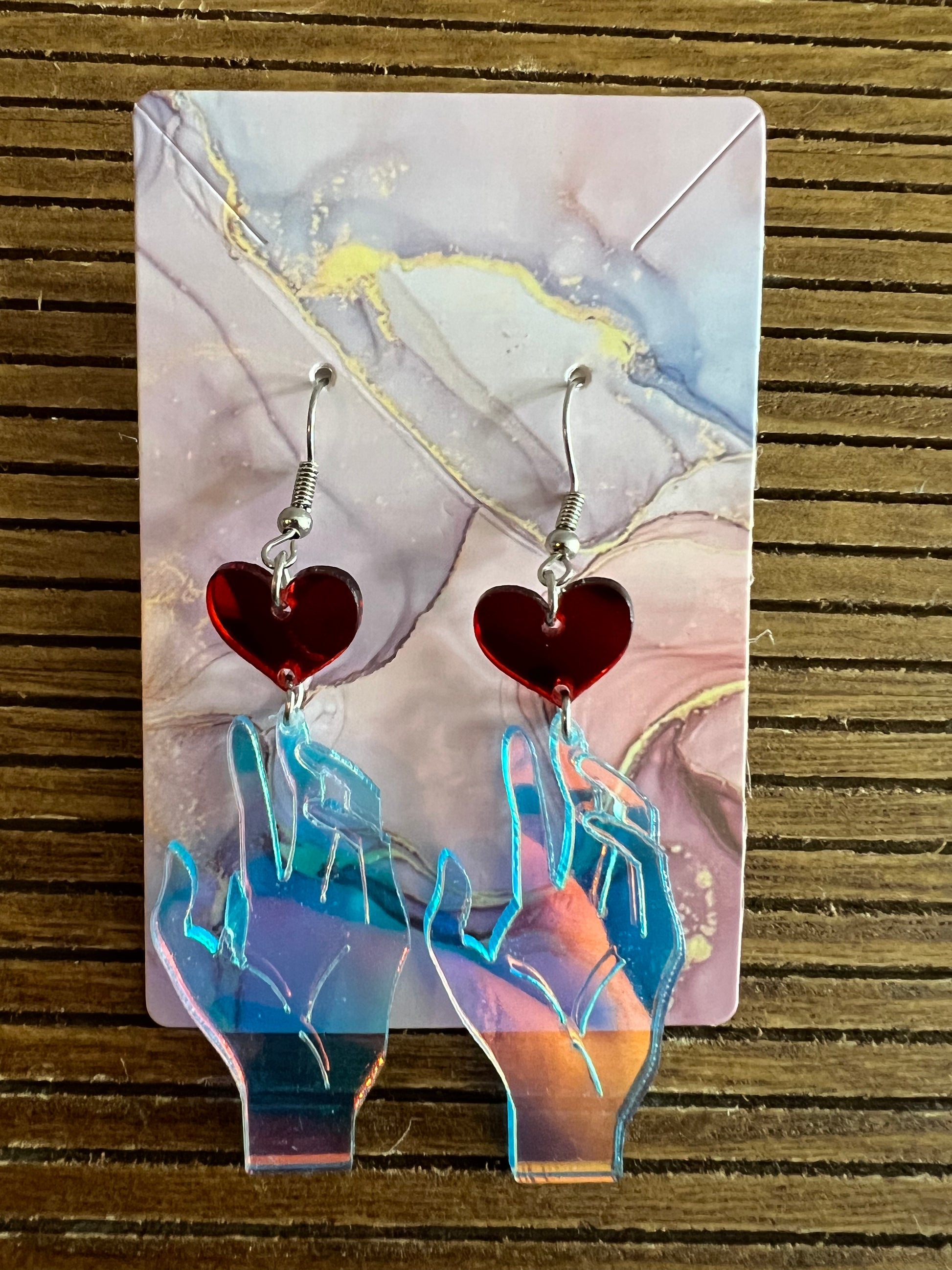 Holographic iridescent earrings in hand and heart design