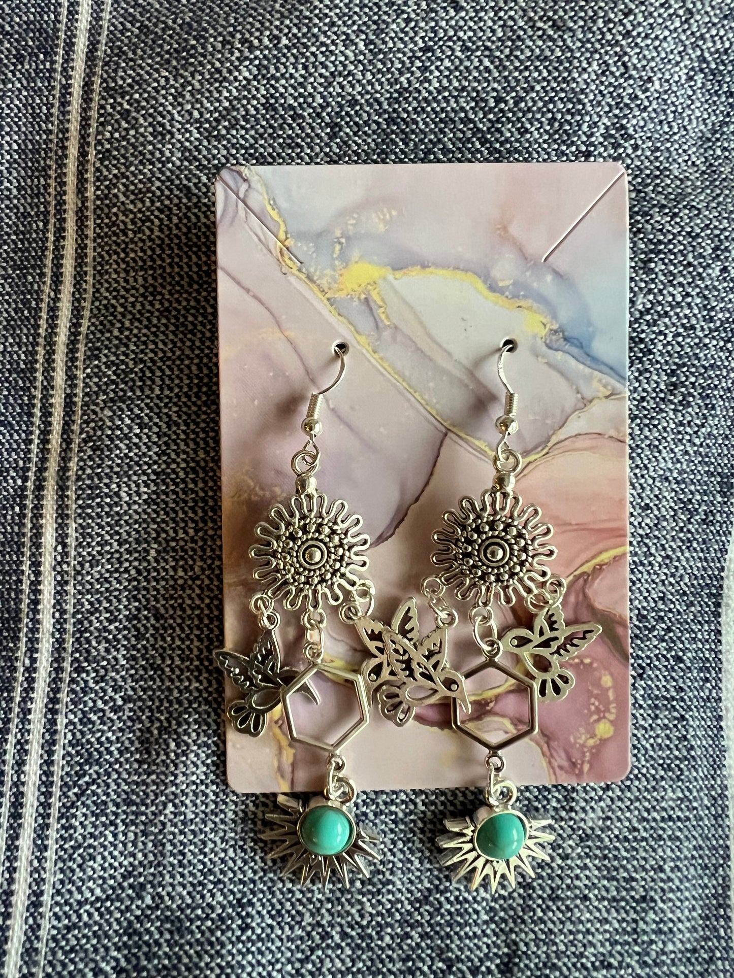 Western style handmade hummingbird earrings in vintage silver