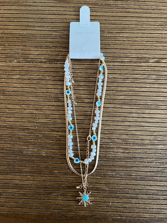 Stackable 3 necklaces with pearls, evil eye design details, snake necklace and a chain necklace with turquoise sun pendant