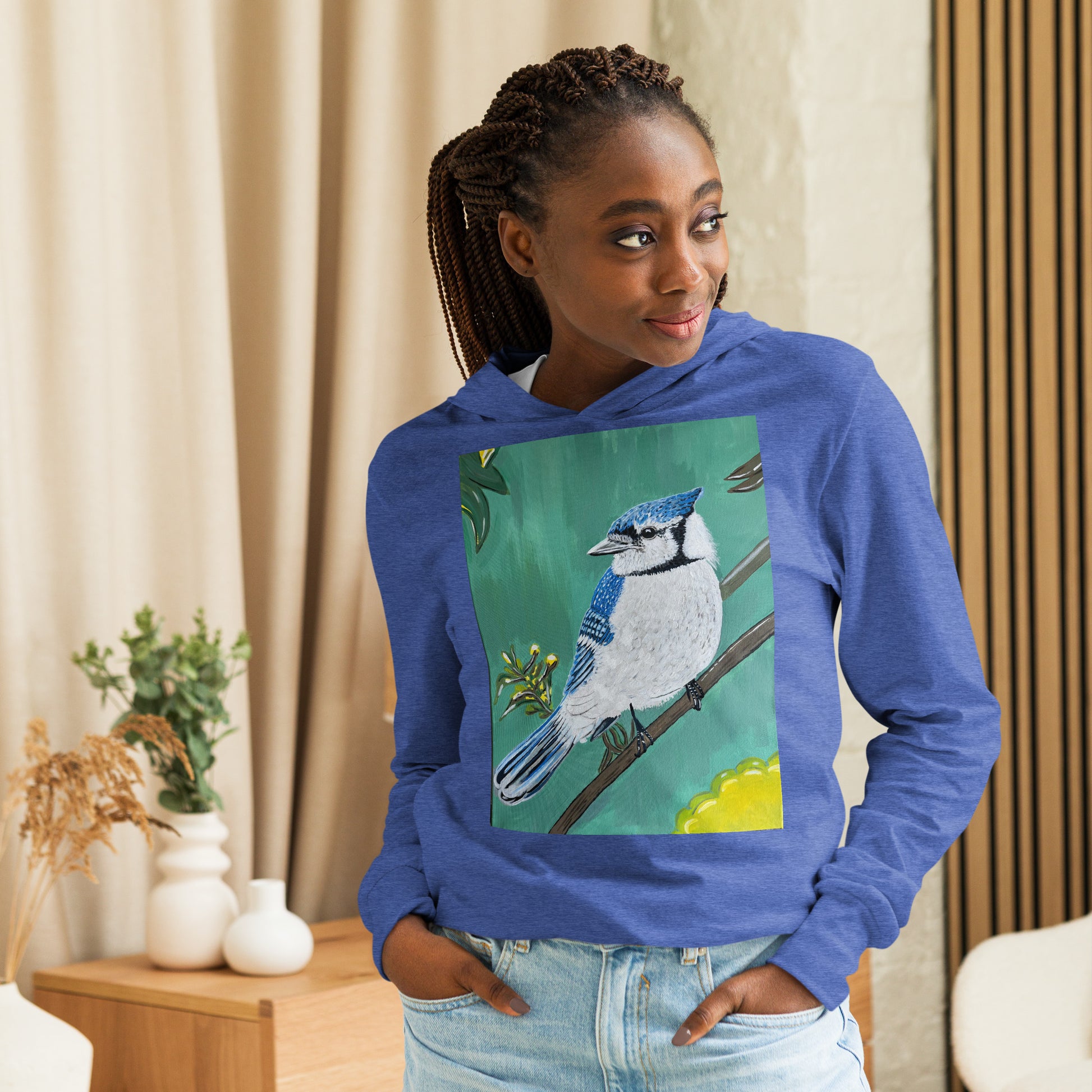 teenage girl wearing Hooded unisex long-sleeve tee with Blue Jay art print in blue